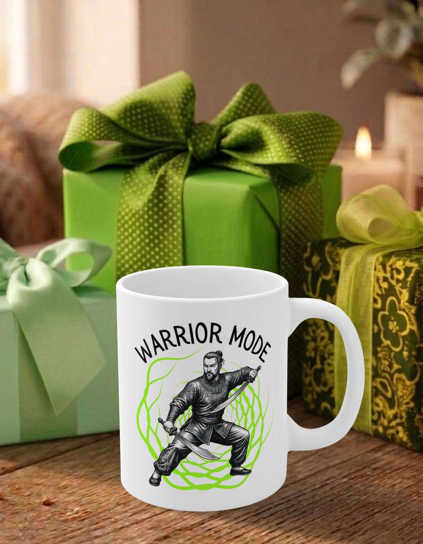 A white 11 oz ceramic mug featuring the slogan — Warrior Mode printed in black letters, above the graphic of a fierce male warrior wielding twin swords, surrounded by a crackling neon green energy field; sits on a wooden table, in front of some thoughtfully wrapped gifts.