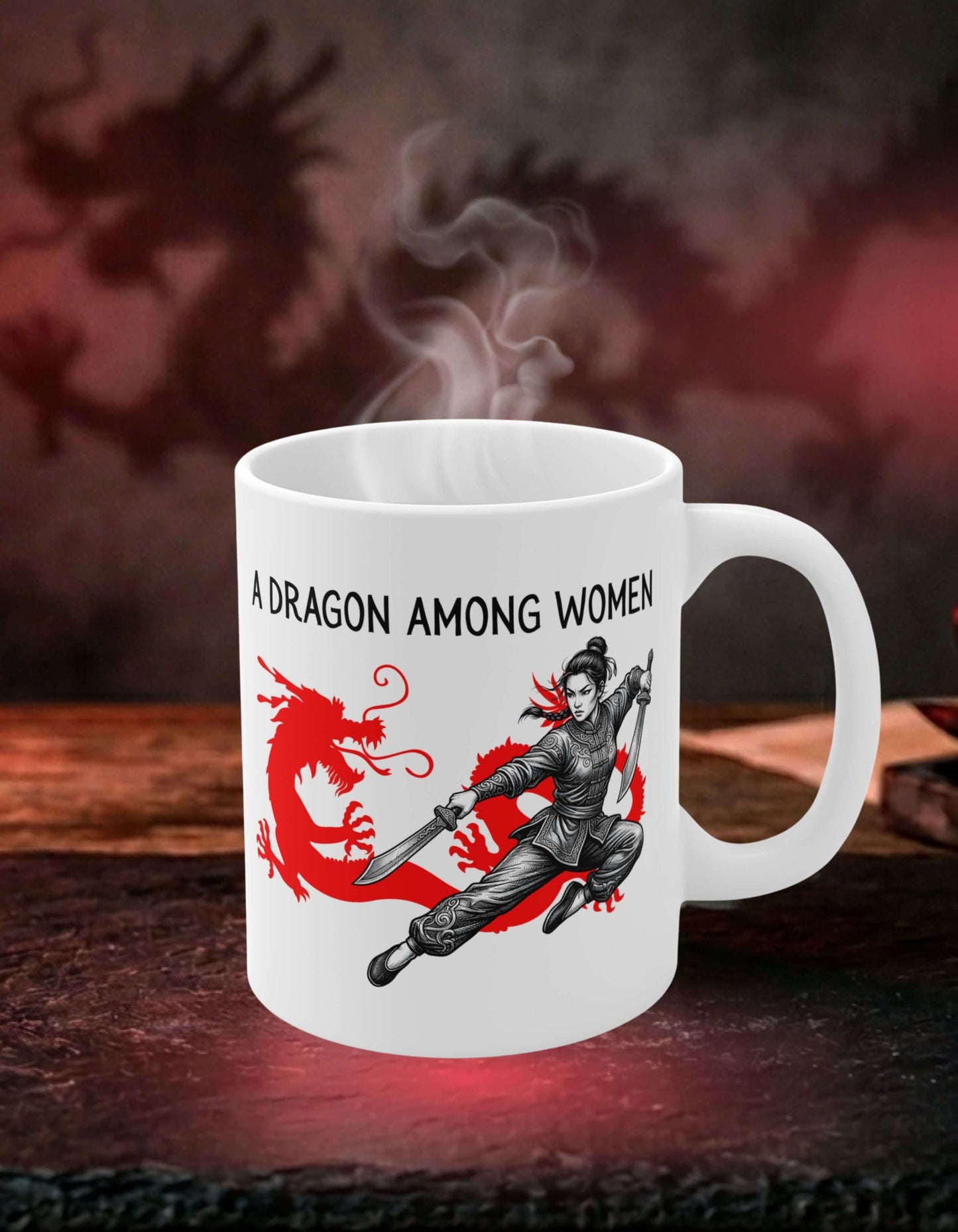White 11 oz ceramic mug with the slogan — A Dragon among Women printed in black letters, above the graphic of a female warrior mid-air wielding twin swords in front of the silhouette of a red Chinese dragon. 