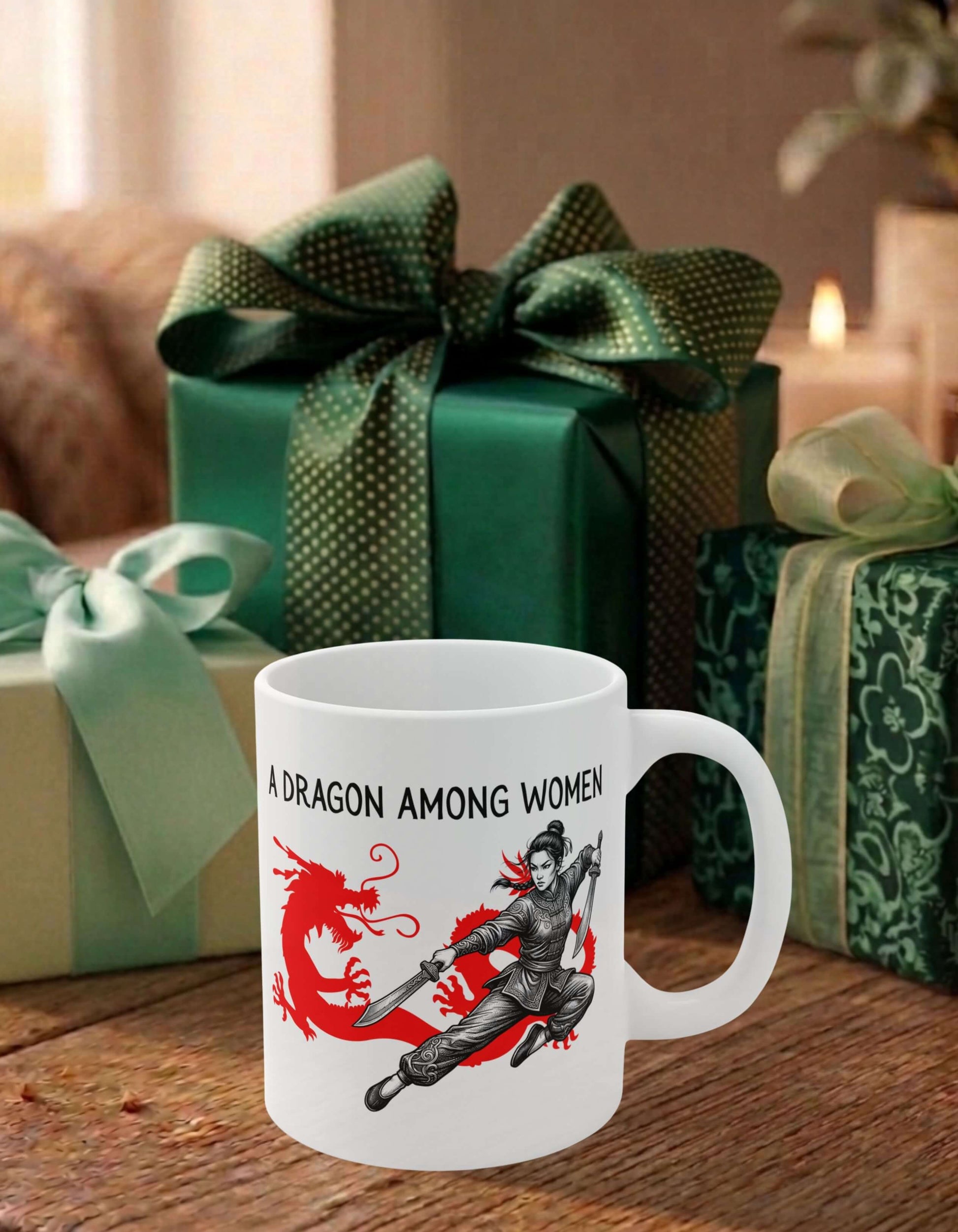 A white 11 oz ceramic mug featuring  the slogan — A Dragon among Women printed in black letters, above the graphic of a female warrior mid-air wielding twin swords in front of the silhouette of a red Chinese dragon; sits on a wooden table, surrounded by thoughtfully wrapped gifts.