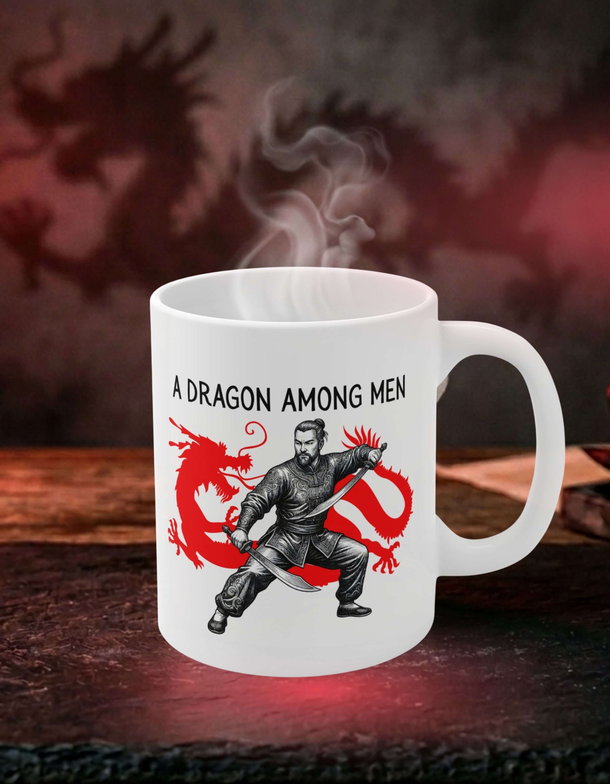 White 11 oz ceramic mug with the slogan — A Dragon among Men printed in black letters, above the graphic of a steadfast male warrior in fight stance wielding twin swords in front of the silhouette of a red Chinese dragon. 